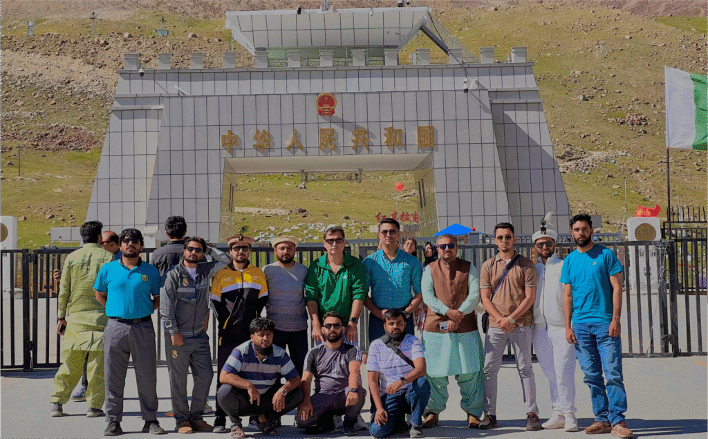 Group photo of happy tourists with Kohsar Tourism Club tour banner.